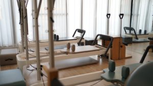 a row of exercise machines in a gym